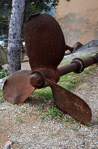 Rusty Ship Propeller on Gravel Ground