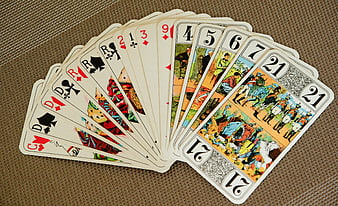 Fan of Traditional Playing Cards on Textured Brown Surface