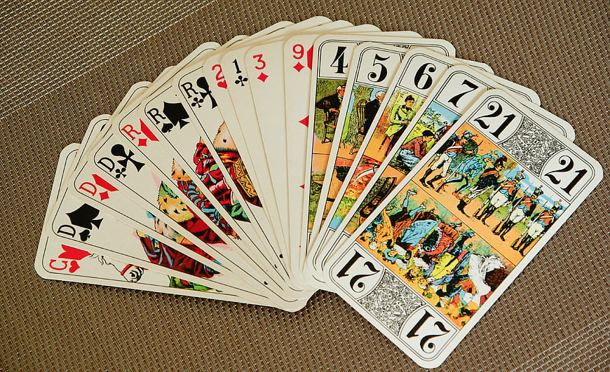Fan of Traditional Playing Cards on Textured Brown Surface
