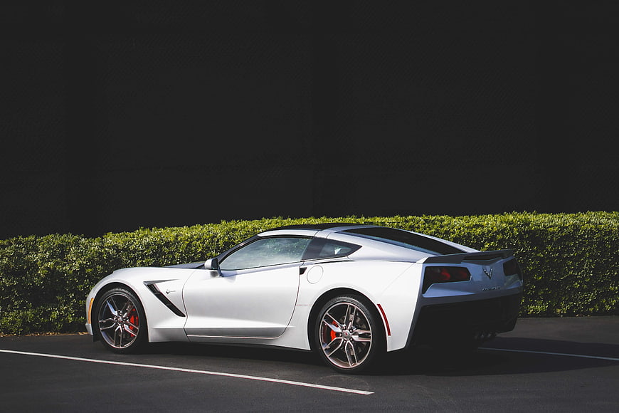 White Sports Car Parked on Asphalt Road