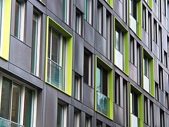 Modern building facade with green window frames