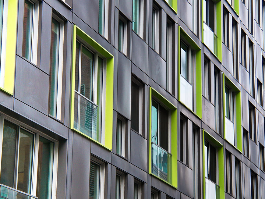Modern building facade with green window frames