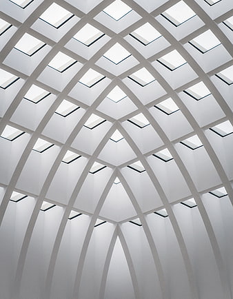 Modern white vaulted ceiling with skylights and geometric arches