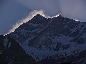 Dramatic Snow-Capped Mountain Peak with Clouds