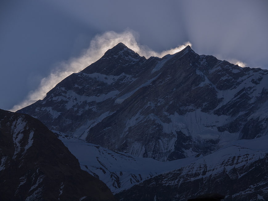 Dramatic Snow-Capped Mountain Peak with Clouds