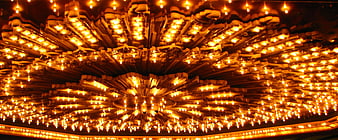 Glowing golden chandelier with radial light pattern
