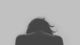 Silhouette of Woman's Back and Hair Against White Background