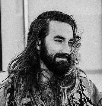 Black and white portrait of bearded man with long hair