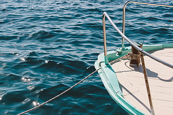 Close-up of boat bow on blue ocean water
