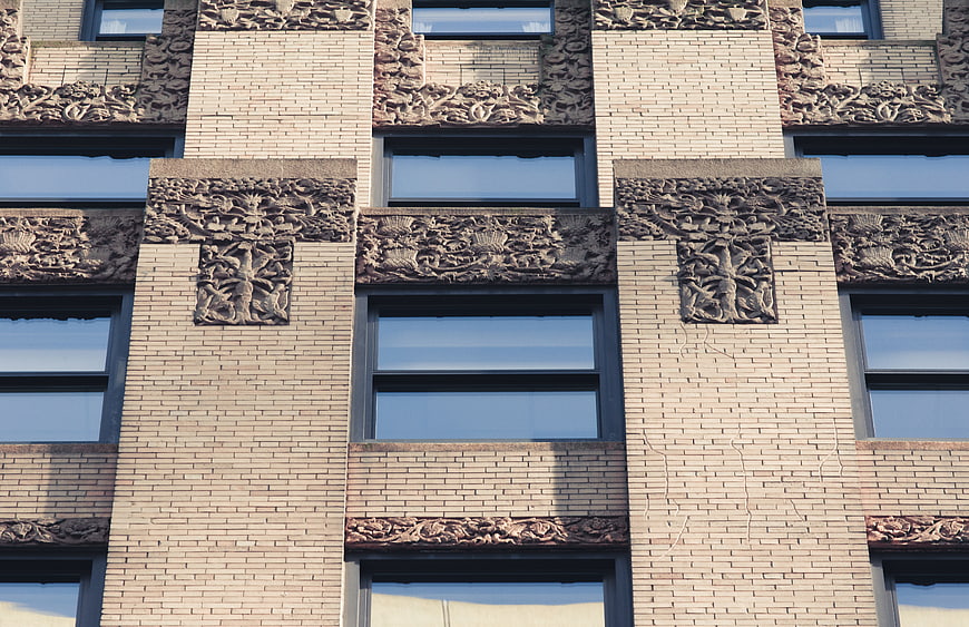 Ornate Brick Building Facade with Stone Reliefs