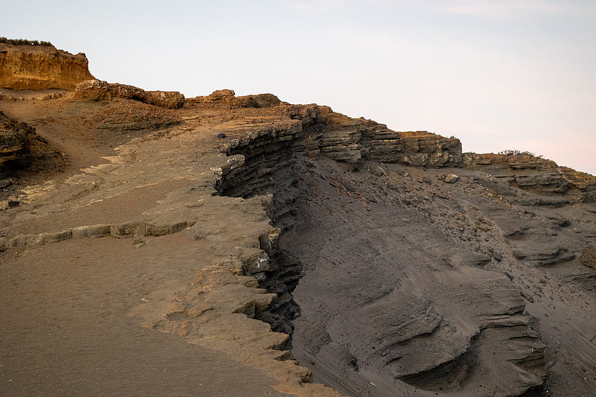 Layered sedimentary rock formations in a desert landscape