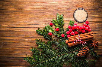 Christmas spices and fir branches on wooden background