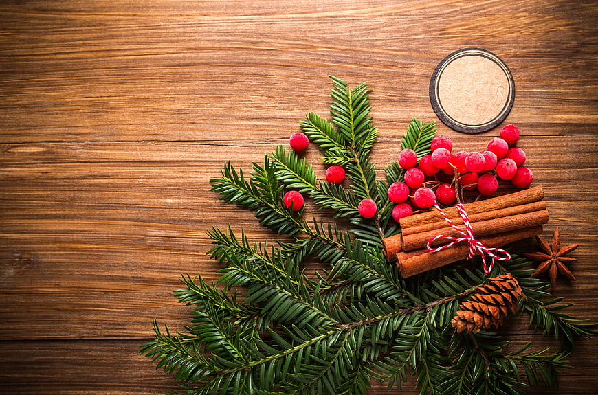 Christmas spices and fir branches on wooden background