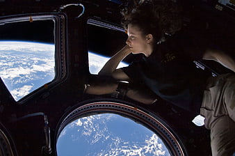 Astronaut relaxing inside the Cupola of the International Space Station