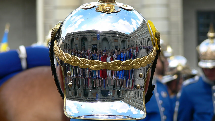Reflection of crowd in shiny ceremonial helmet
