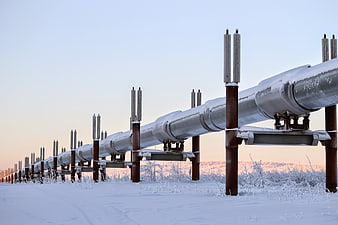 Snow-covered industrial pipeline structure in a winter landscape