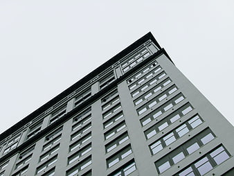 Low angle view of modern gray office building facade