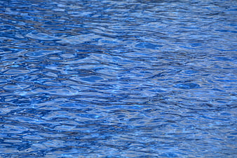Close-up of rippling blue swimming pool water surface texture