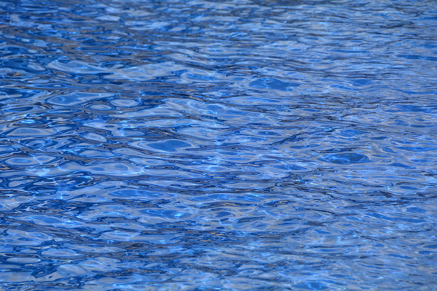 Close-up of rippling blue swimming pool water surface texture