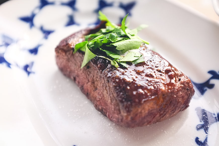 Grilled Beef Steak with Fresh Herbs on Decorative Plate
