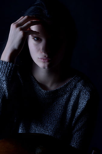 Moody Portrait Of A Sad Young Woman In A Knit Sweater