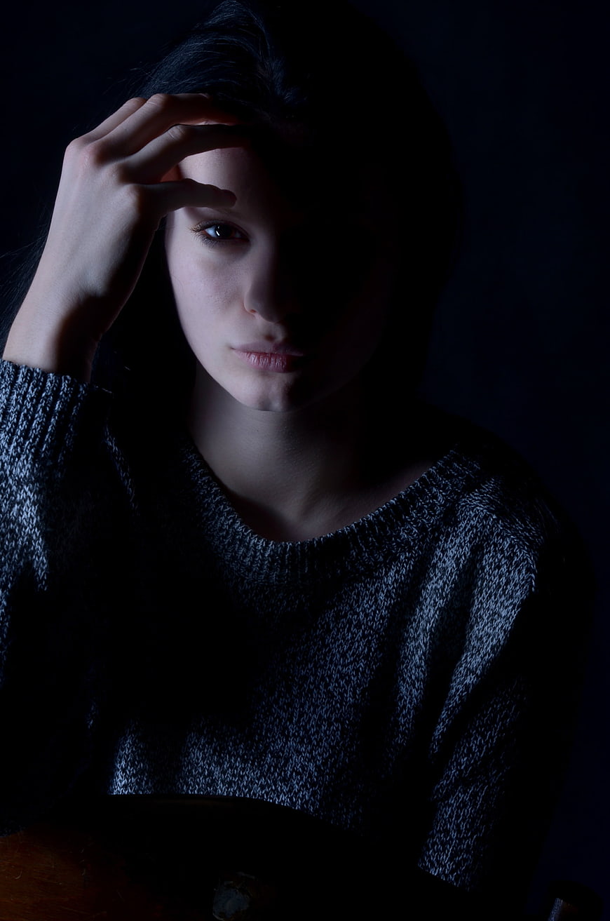 Moody Portrait Of A Sad Young Woman In A Knit Sweater
