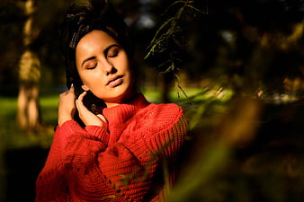 Woman in Red Sweater with Eyes Closed in Sunlight