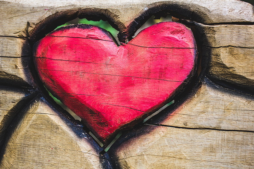 Red Heart Carved into Weathered Wooden Planks