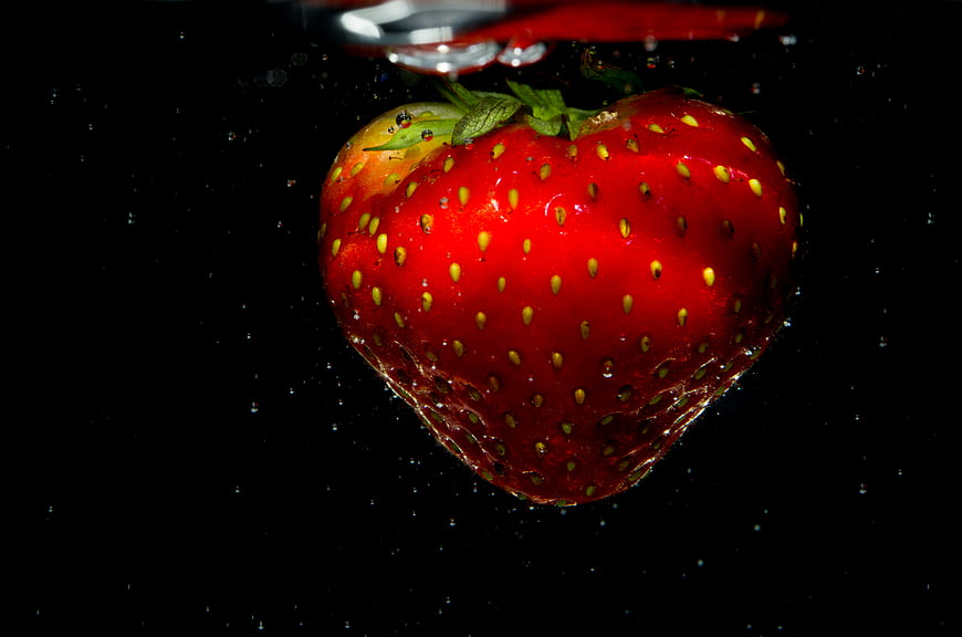 Fresh Strawberry Submerged in Water with Bubbles