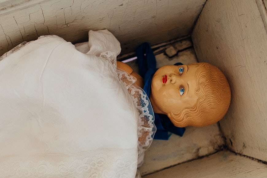 Vintage doll in wooden box with lace dress