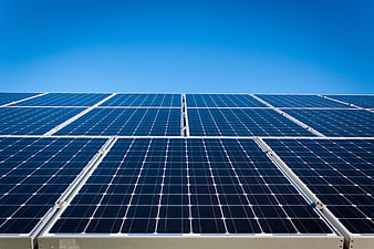 Blue solar panels against clear sky for renewable energy