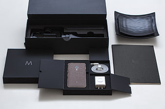 Motorola smartphone unboxing with accessories and black packaging