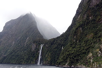 Misty Mountain Waterfall in New Zealand Fjord Landscape