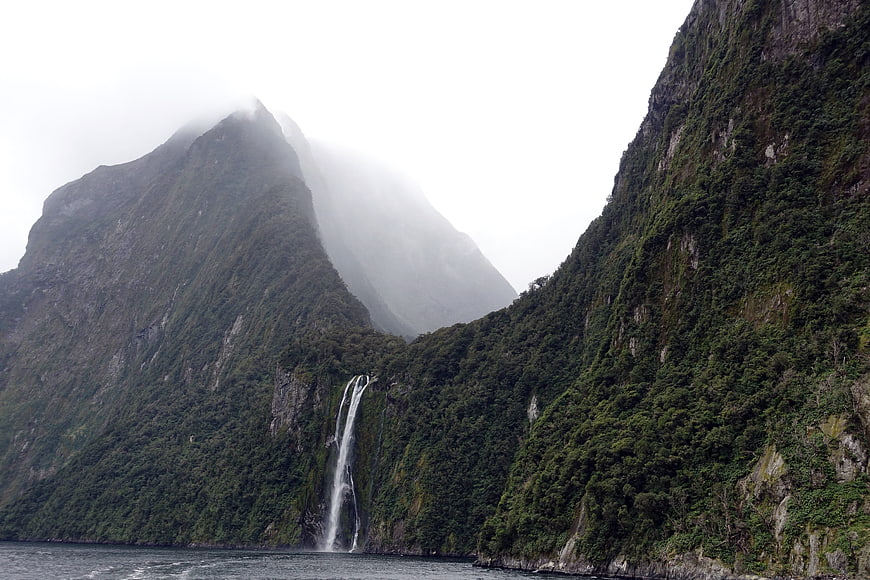 Misty Mountain Waterfall in New Zealand Fjord Landscape