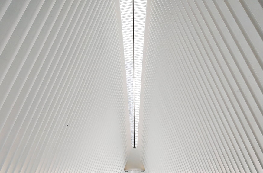 White Architectural Ceiling With Symmetrical Ribs And Central Skylight