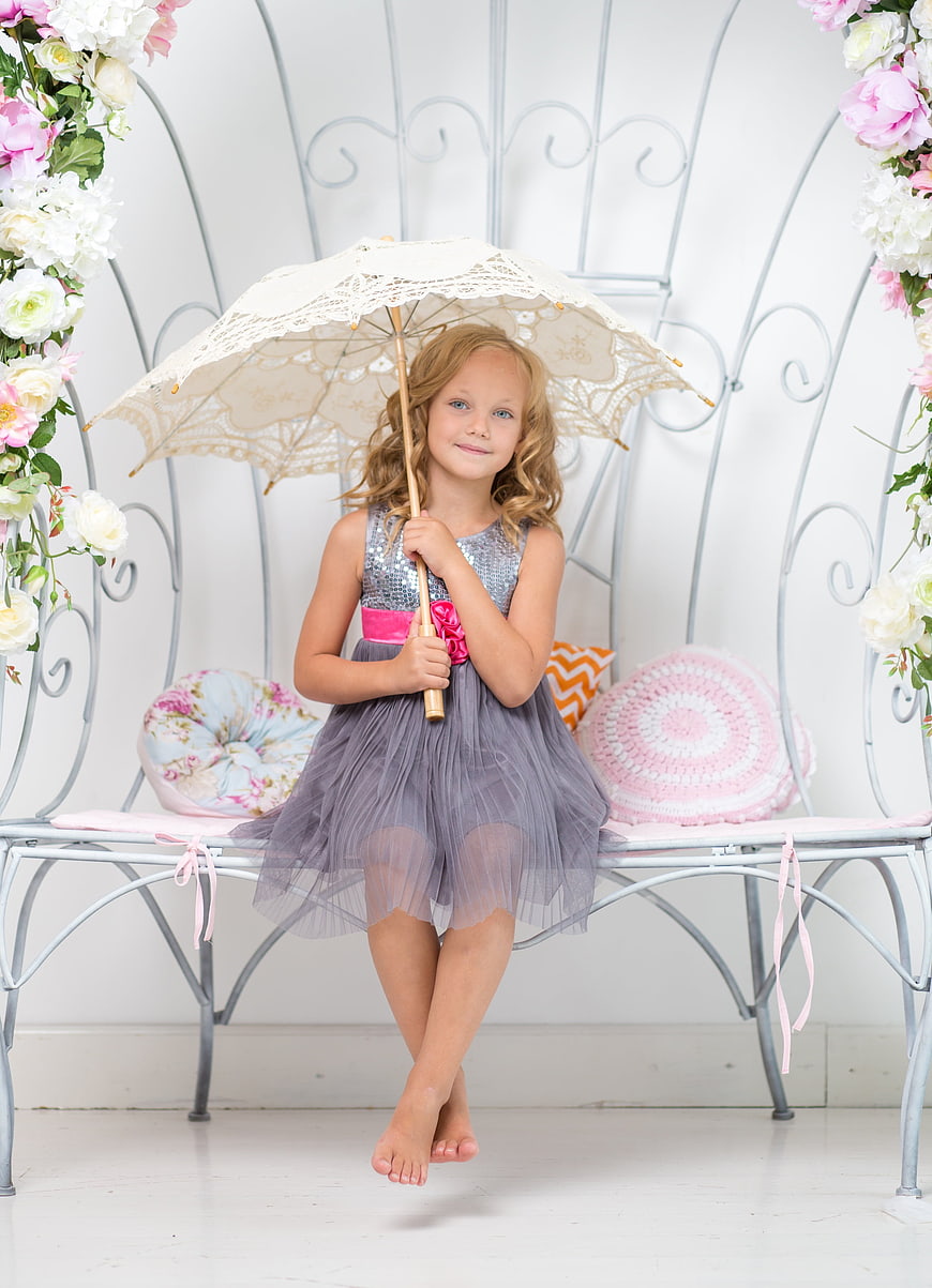 Cute Little Girl Sitting on Bench with Lace Parasol
