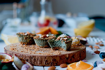Green Matcha Mini Tarts with Almonds on Wooden Board