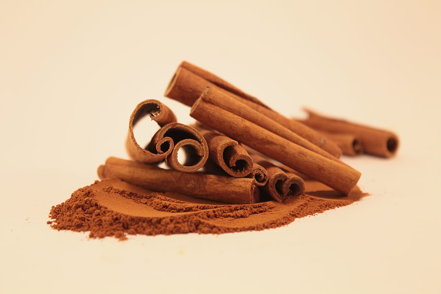 Cinnamon Sticks and Ground Powder on White Background