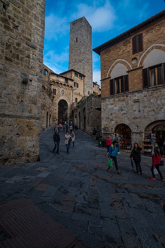 Medieval stone tower and cobblestone street in San Gimignano, Tuscany