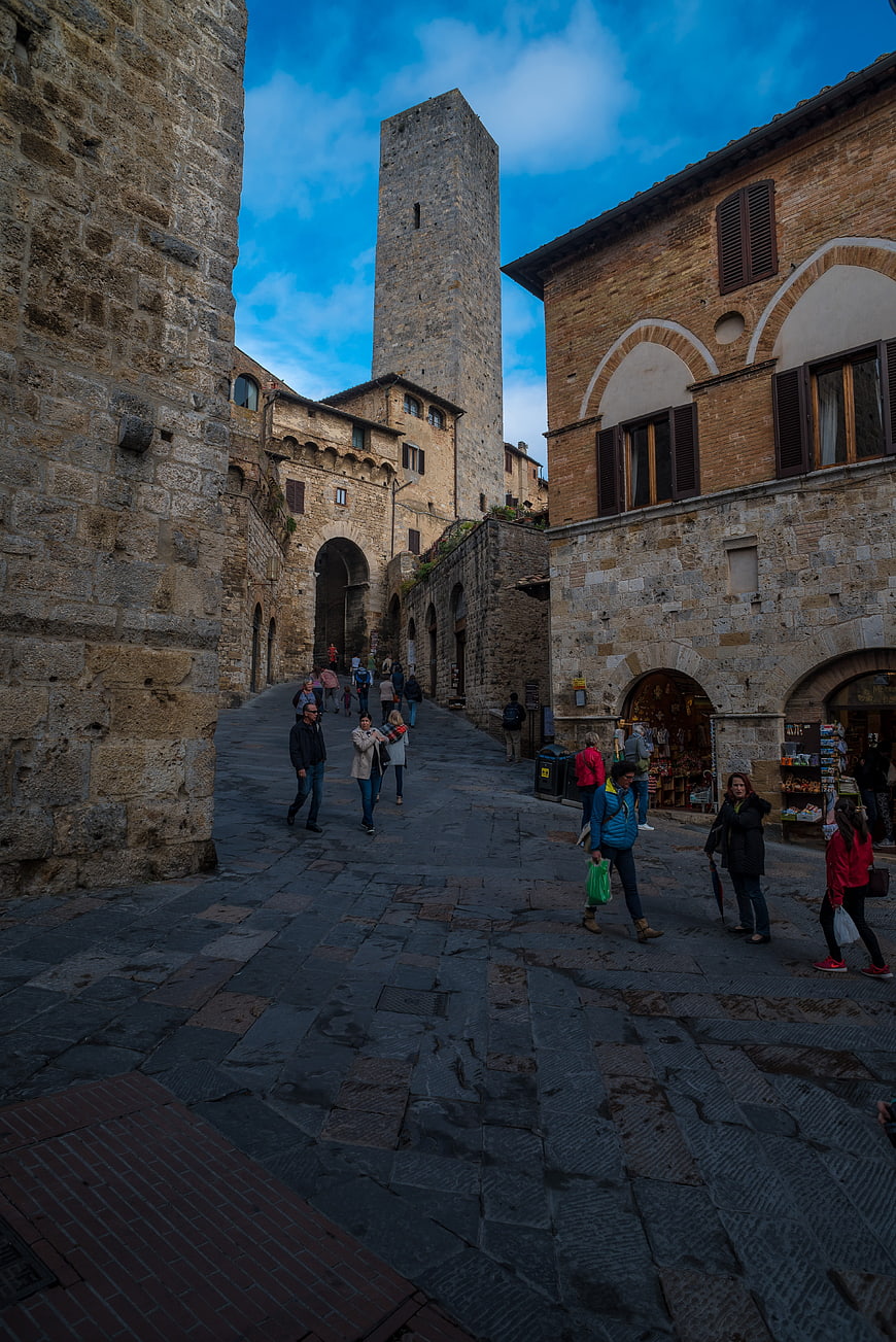 Medieval stone tower and cobblestone street in San Gimignano, Tuscany