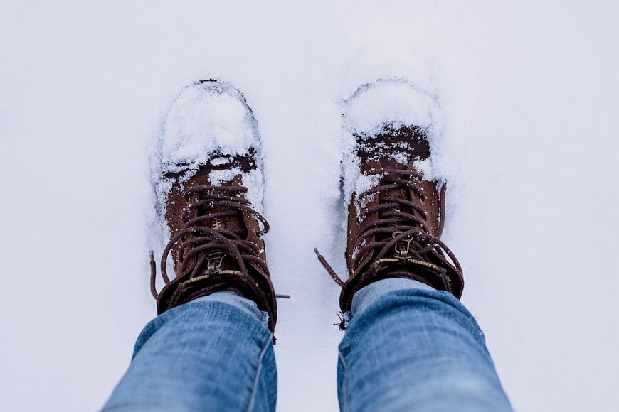 First Person View of Brown Boots in Snow