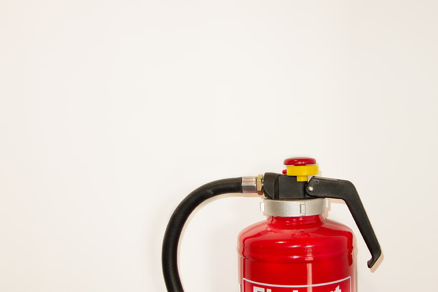 Red Fire Extinguisher On White Background