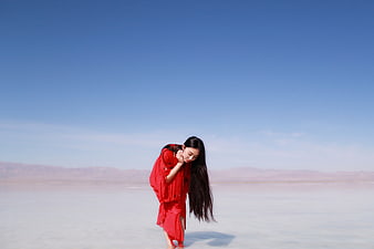 Woman in Red Dress Standing on White Salt Lake