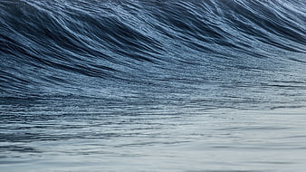 Close-up of deep blue ocean wave with smooth texture