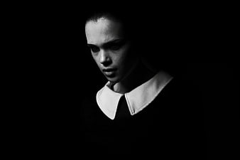 Dramatic Black and White Portrait of Young Woman in White Collar