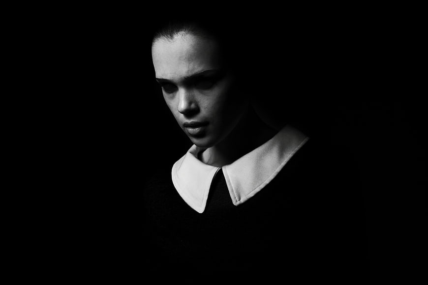 Dramatic Black and White Portrait of Young Woman in White Collar
