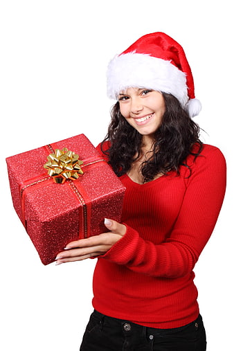 Smiling young woman in red sweater and Santa hat holding a red gift box