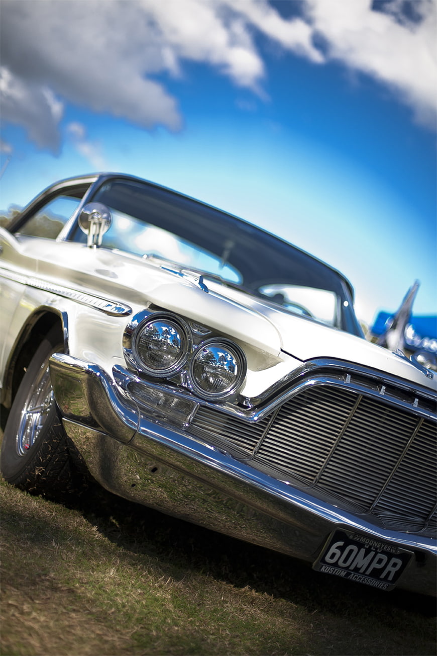 Low angle shot of white classic car front grille