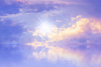 Serene pastel sunset sky with sun reflection on calm water
