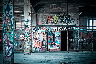 Colorful graffiti art in abandoned industrial warehouse interior